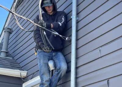 Electrician working on exterior home wiring
